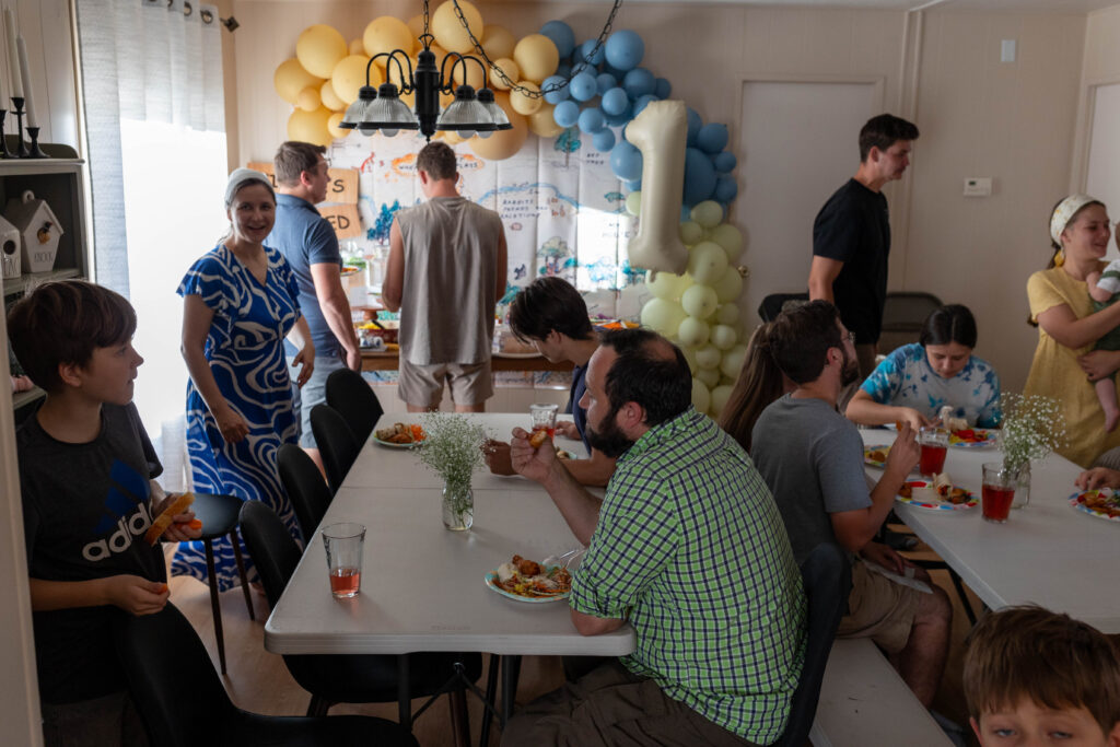 people sitting at table enjoying party