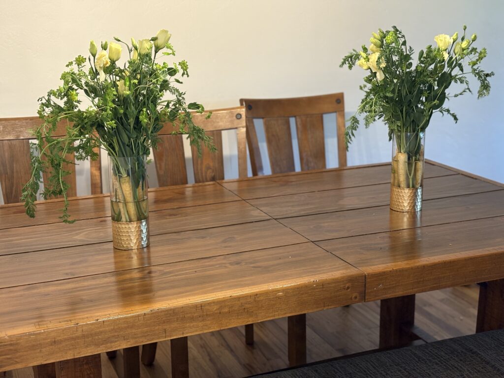 Two bouquets on the dining table.