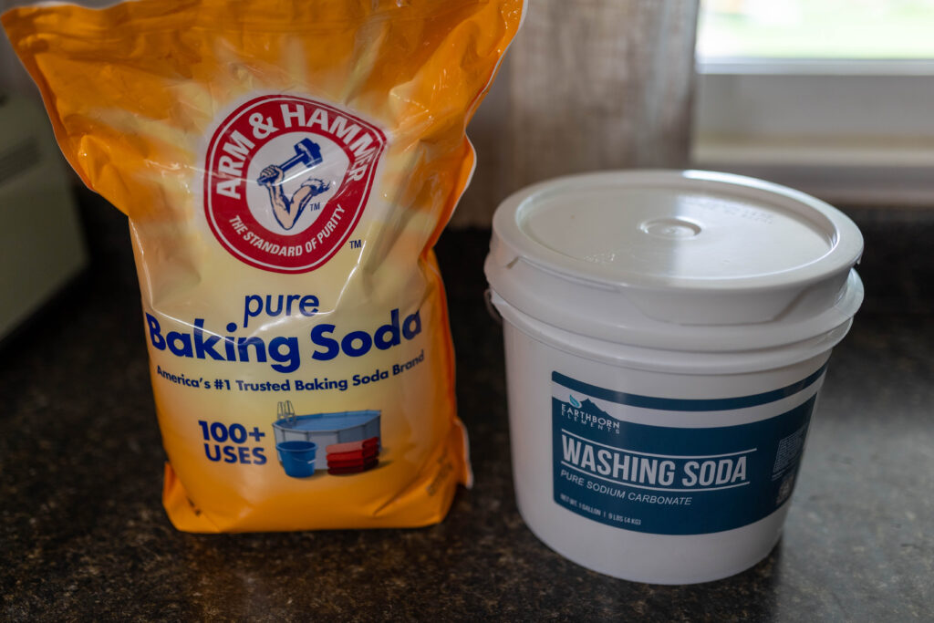 bag of baking soda and bucket of washing soda on kitchen counter