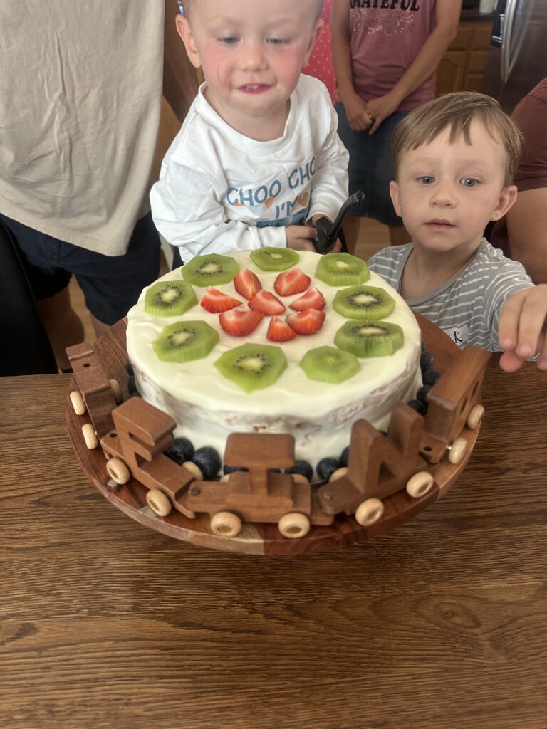 cake with fruit on it and train near it