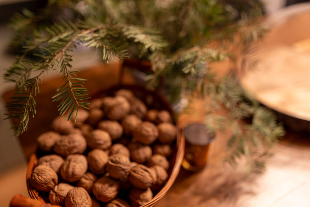 walnuts and a Christmas centerpiece with a golden candle