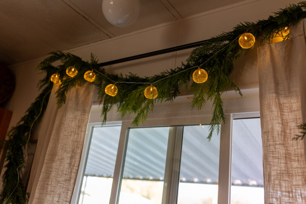 greenery garland with lights hanging in the kitchen