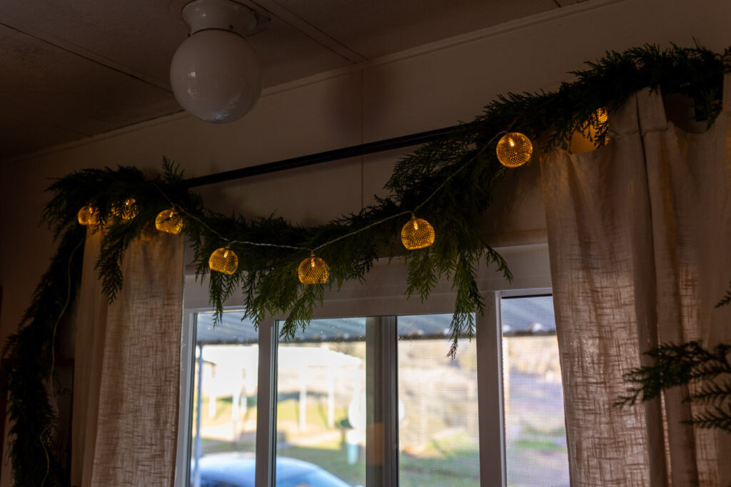 garland hanging over a window with lights