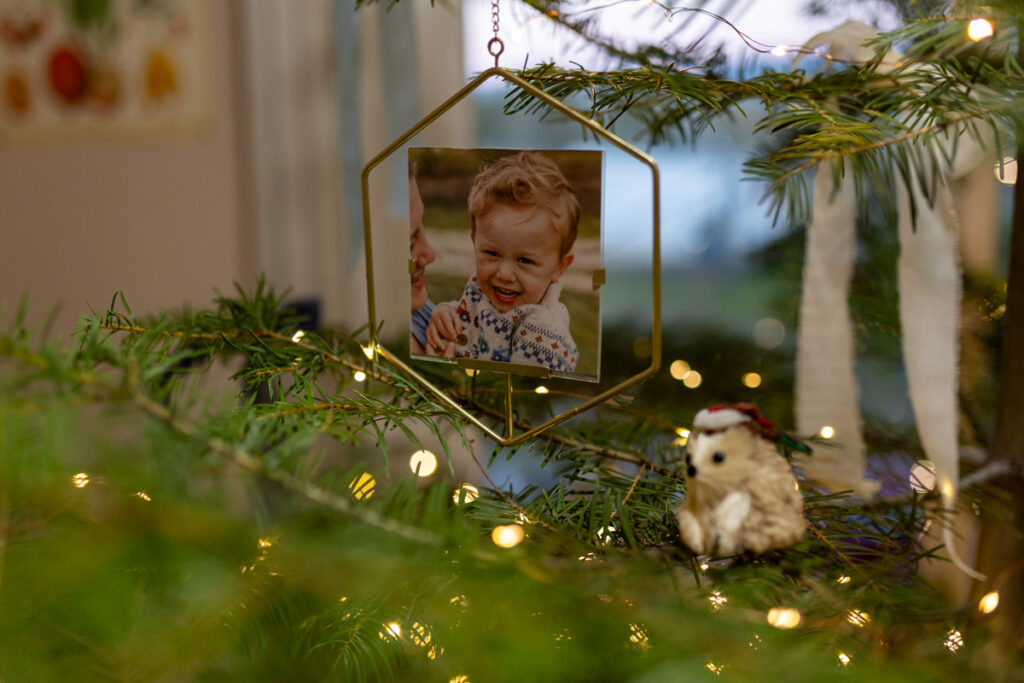 a hexagon shaped golden ornament on a tree