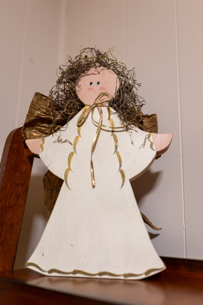 a white and golden wooden angel