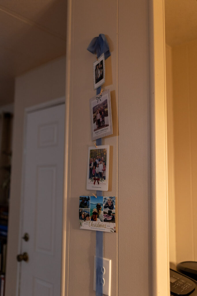 blue ribbon hanging with Christmas photo cards