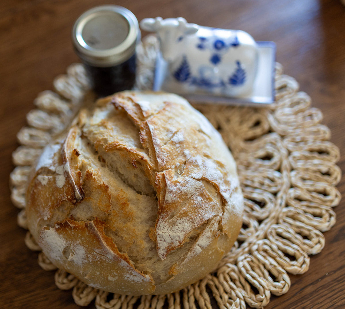 sourdough bread with a cow butter dish and a jar of jam