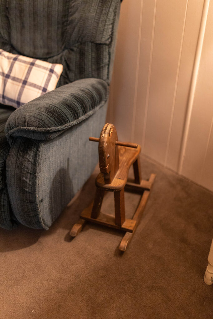 little rocking horse next to lazy boy chair