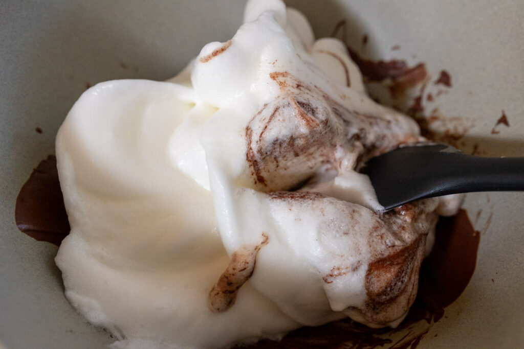 mixing the egg whites into the chocolate
