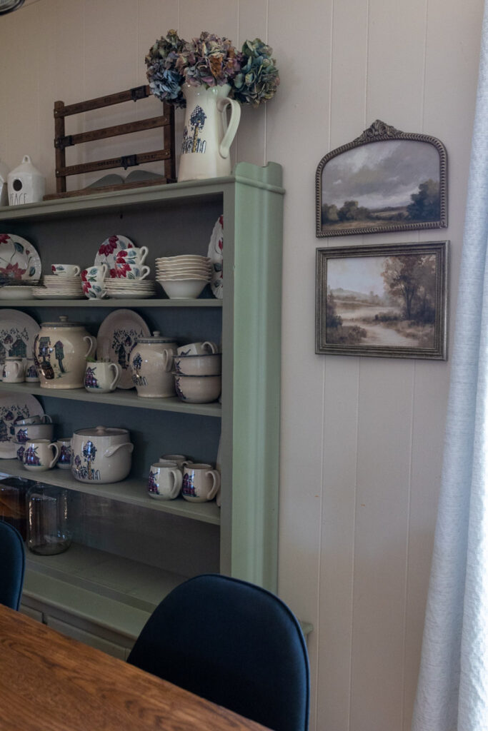 frames hanging to the right of a hutch
