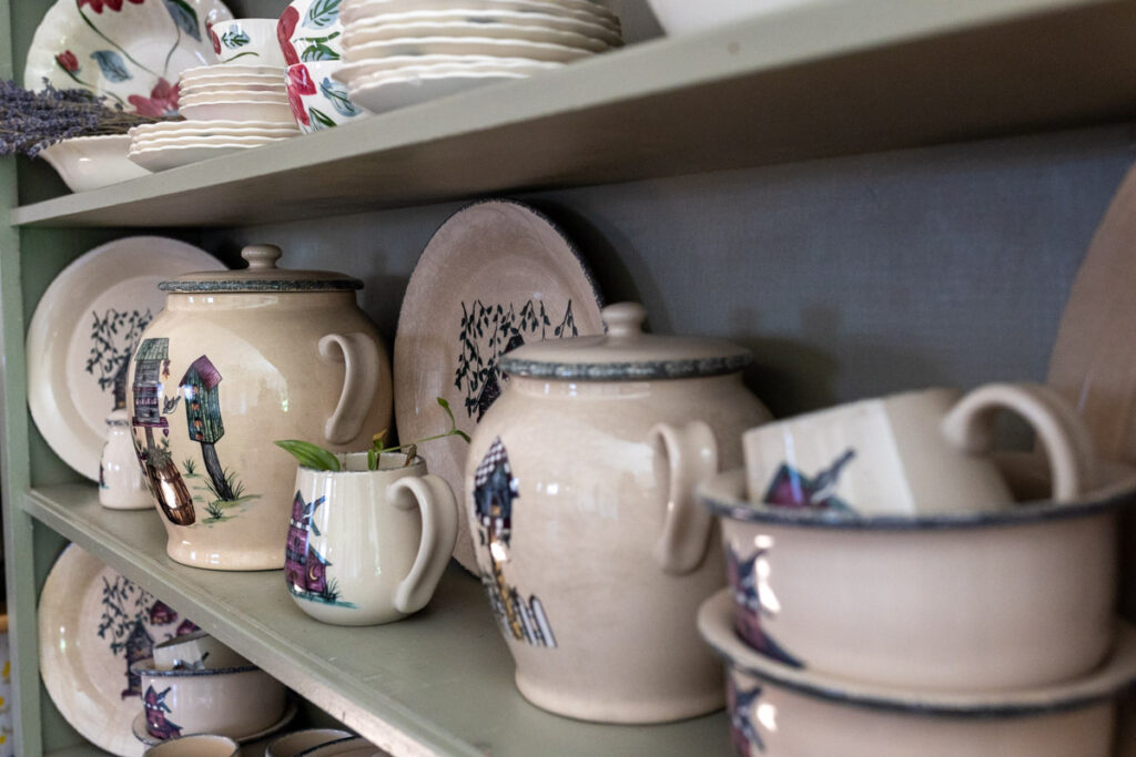 set of antique dinnerware displayed on a shelf
