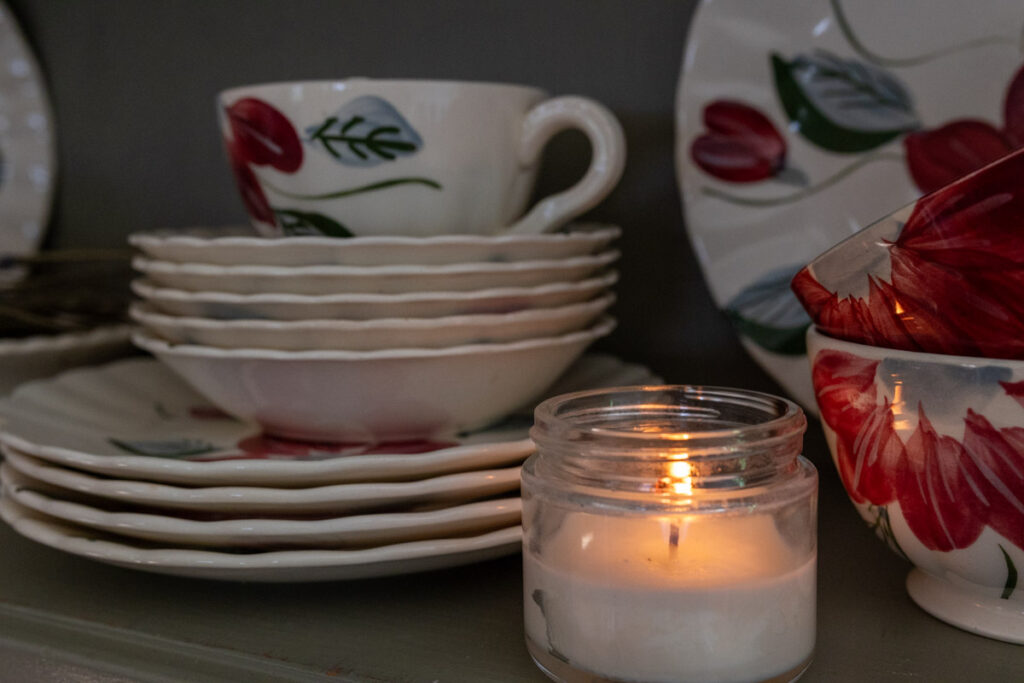 dishes with a candle on a cabinet