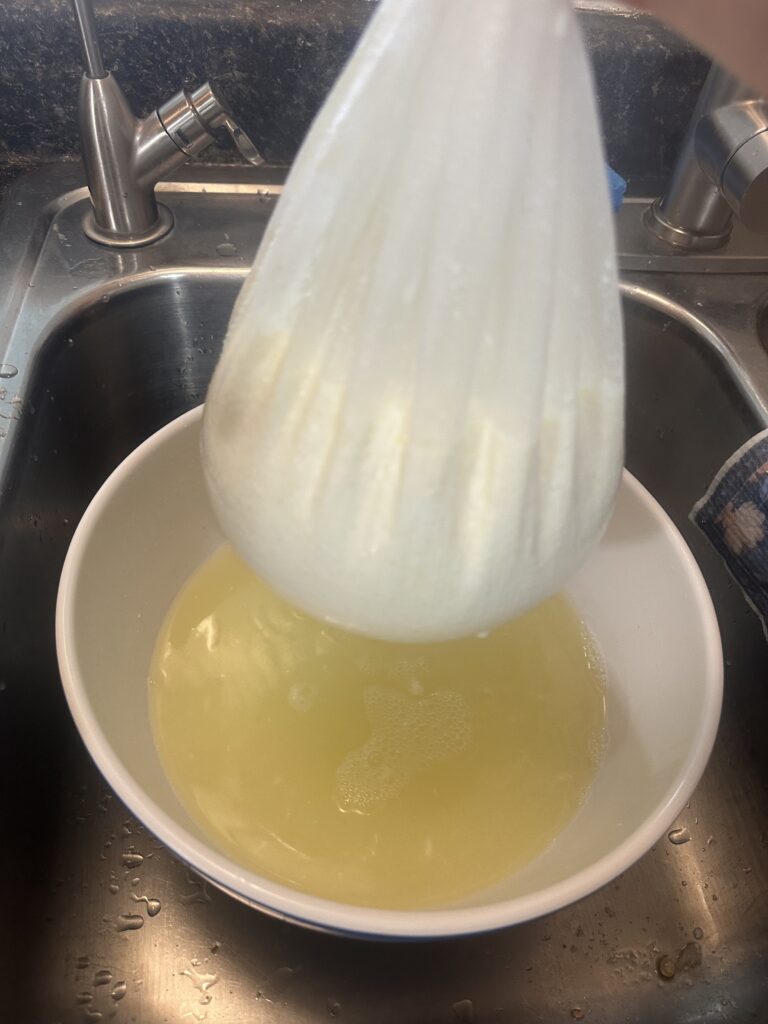 whey dripping out of the cottage cheese