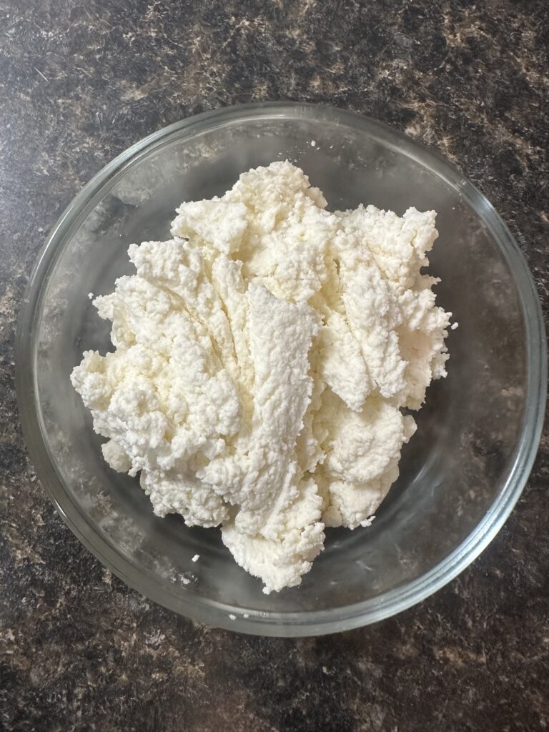 homemade cottage cheese in a glass bowl