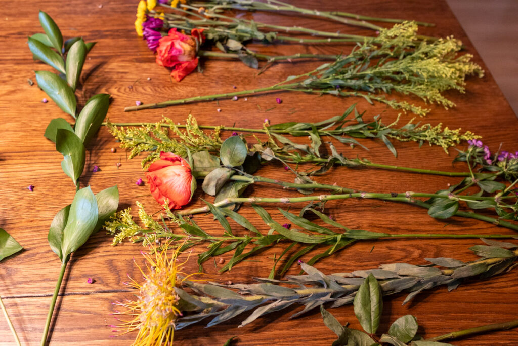 fresh flowers laid out on table for project