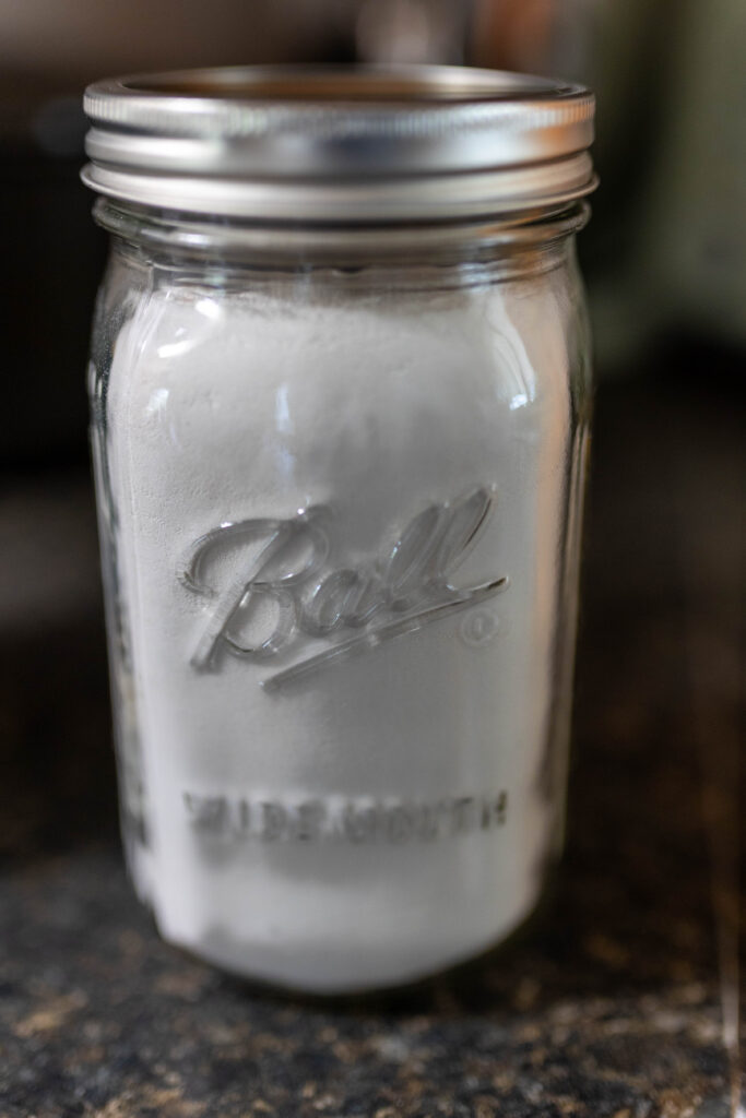 dishwasher detergent in powder form in a mason jar