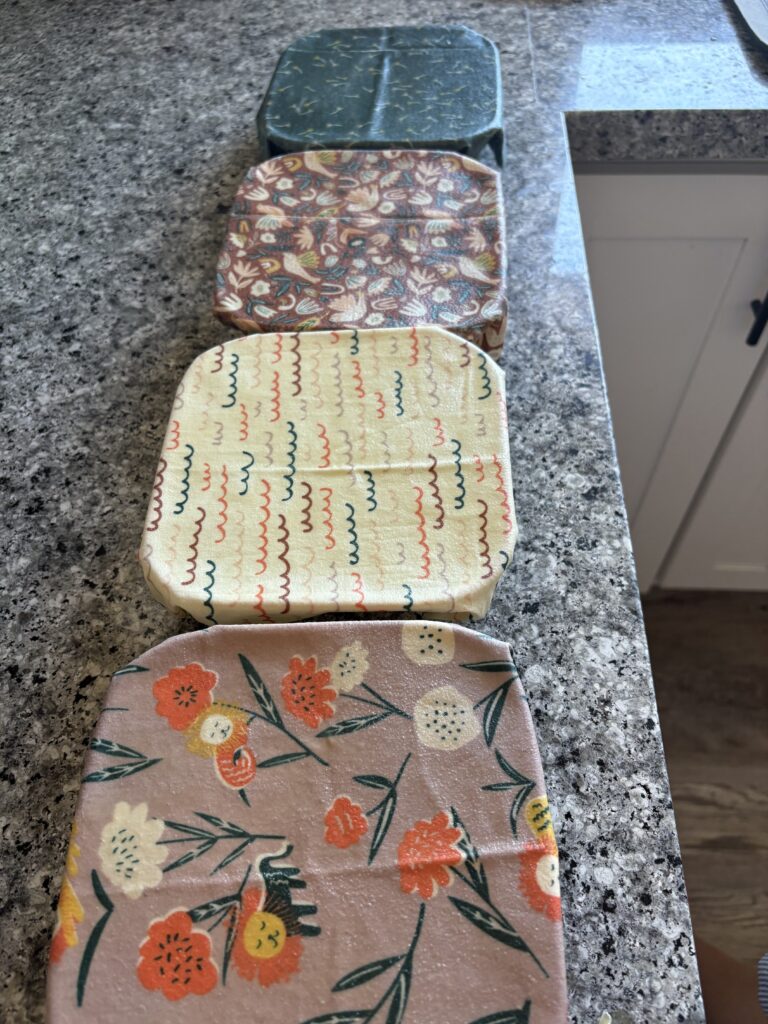 Four bowls wrapped in beeswax wraps.